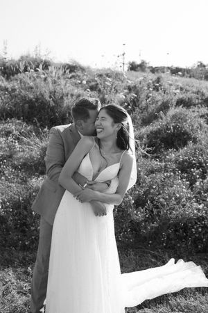 A romantic black and white wedding photo series showing a couple embracing in an outdoor nature setting.