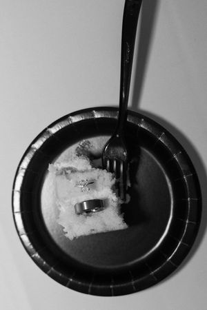 A sequence of black and white photos showing salt being poured onto a dark plate in a time-lapse progression.