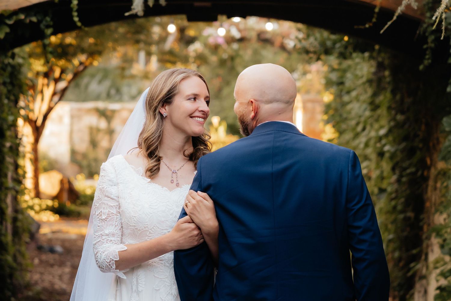 Wedding Couple standing side by side looking at each other at Thanksgiving Point Garden in Lehi, Utah