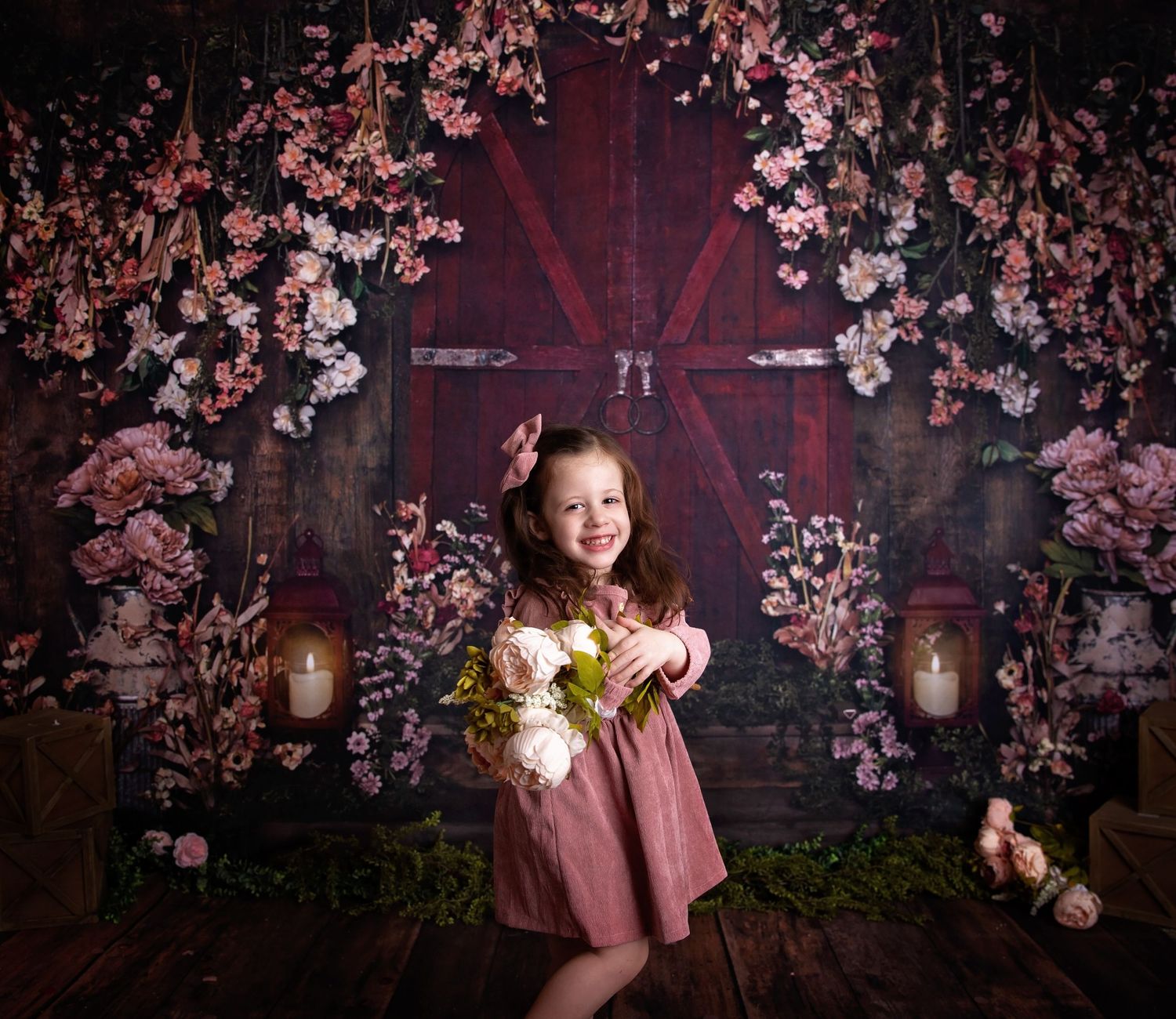 Enchanting children's portrait setup with pink cherry blossoms and moody lighting.