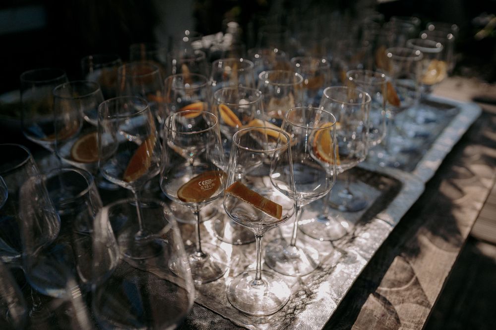 Collection of empty wine glasses arranged on a dark table surface.