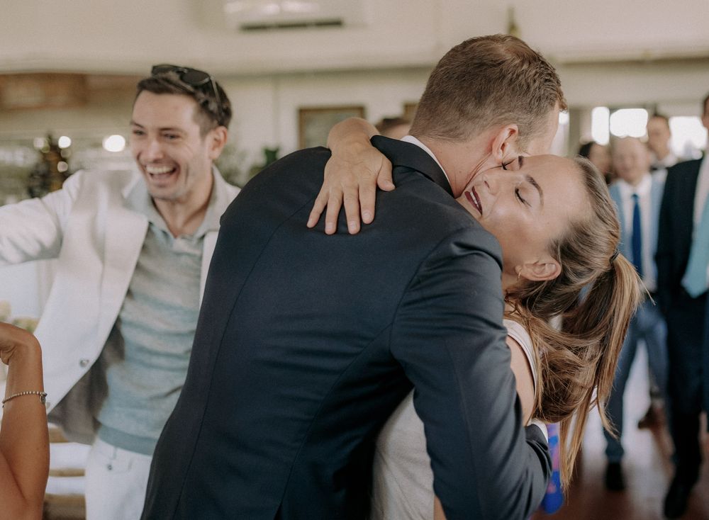 Celebratory moment captured during a festive indoor gathering with guests showing emotion.