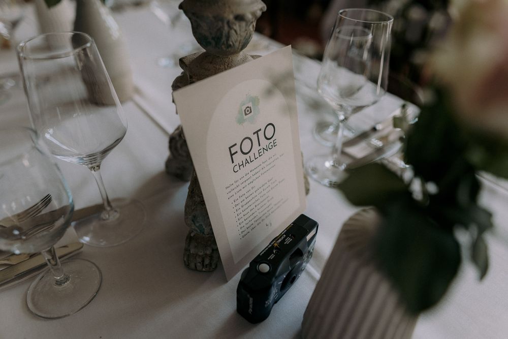 Elegant table setting with wine glasses and FOTO menu card.