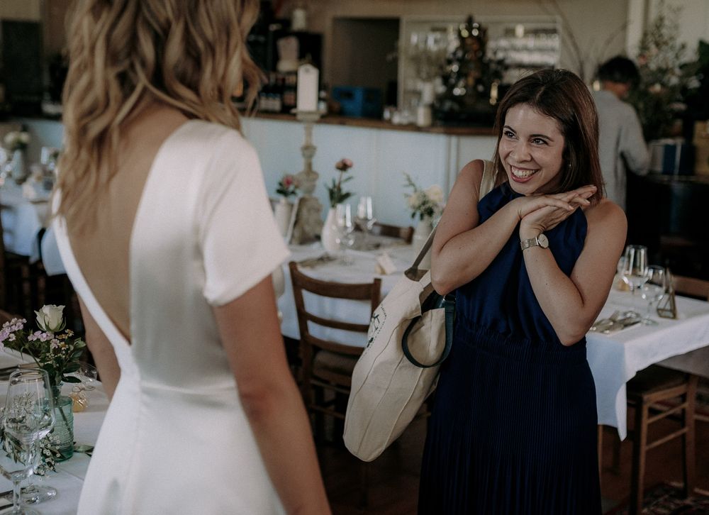 Two guests interacting at elegant indoor dining event.