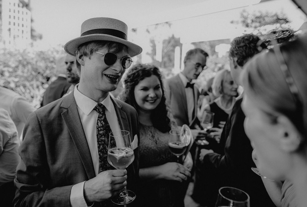 People enjoying drinks and conversation at an outdoor social event.