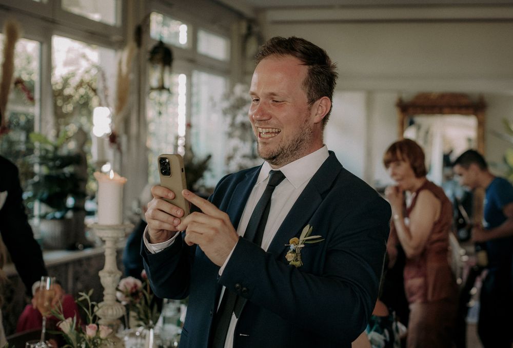 Guest enjoying a celebratory moment at an elegant indoor reception.