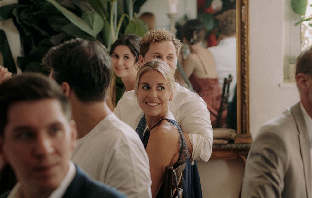 Guests mingle and socialize during an elegant indoor wedding reception.