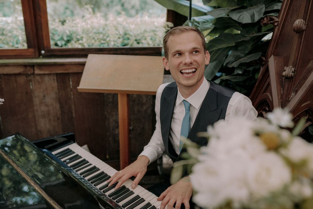 Wedding entertainment with musical performance at keyboard in rustic indoor setting.