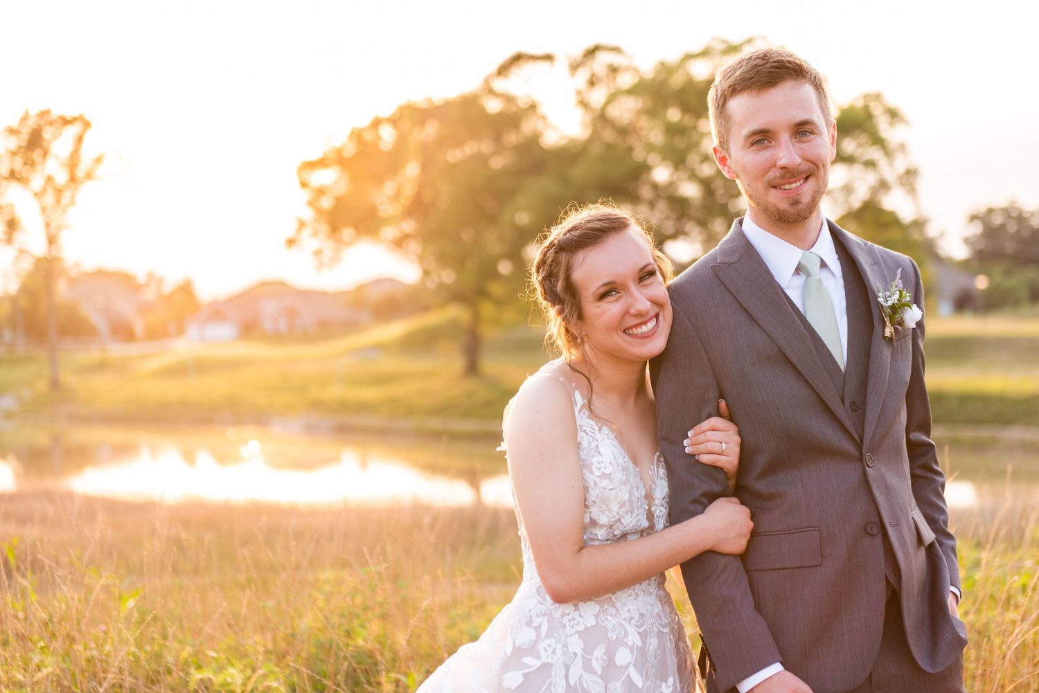 woman holds onto the arm of a man in a tux