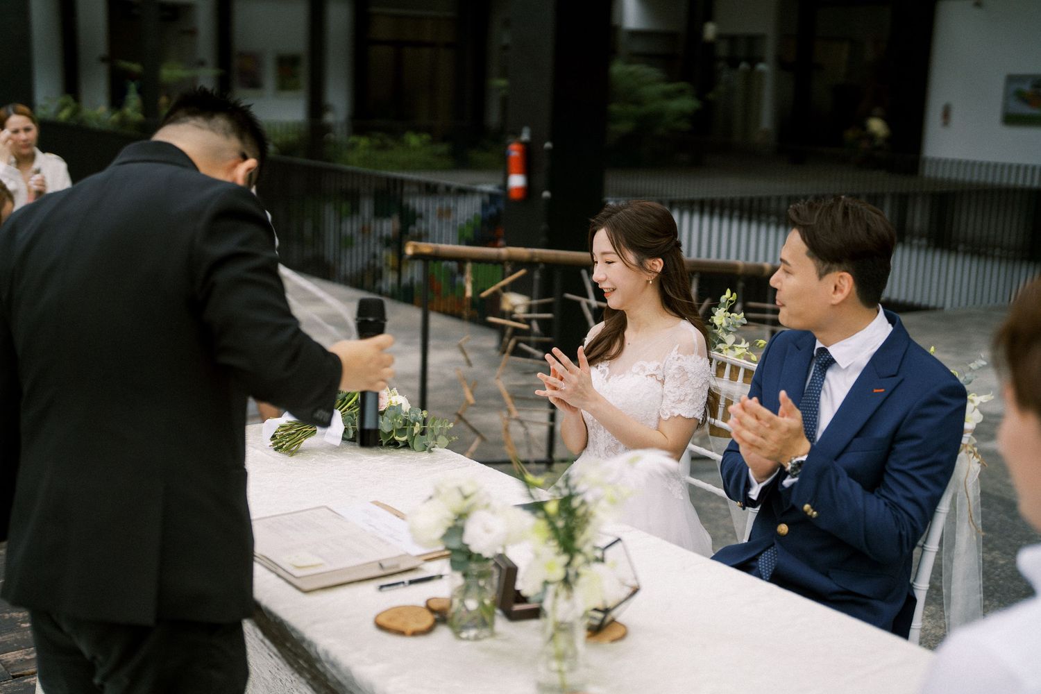 Wedding guests seated at elegant dining tables during an indoor reception.