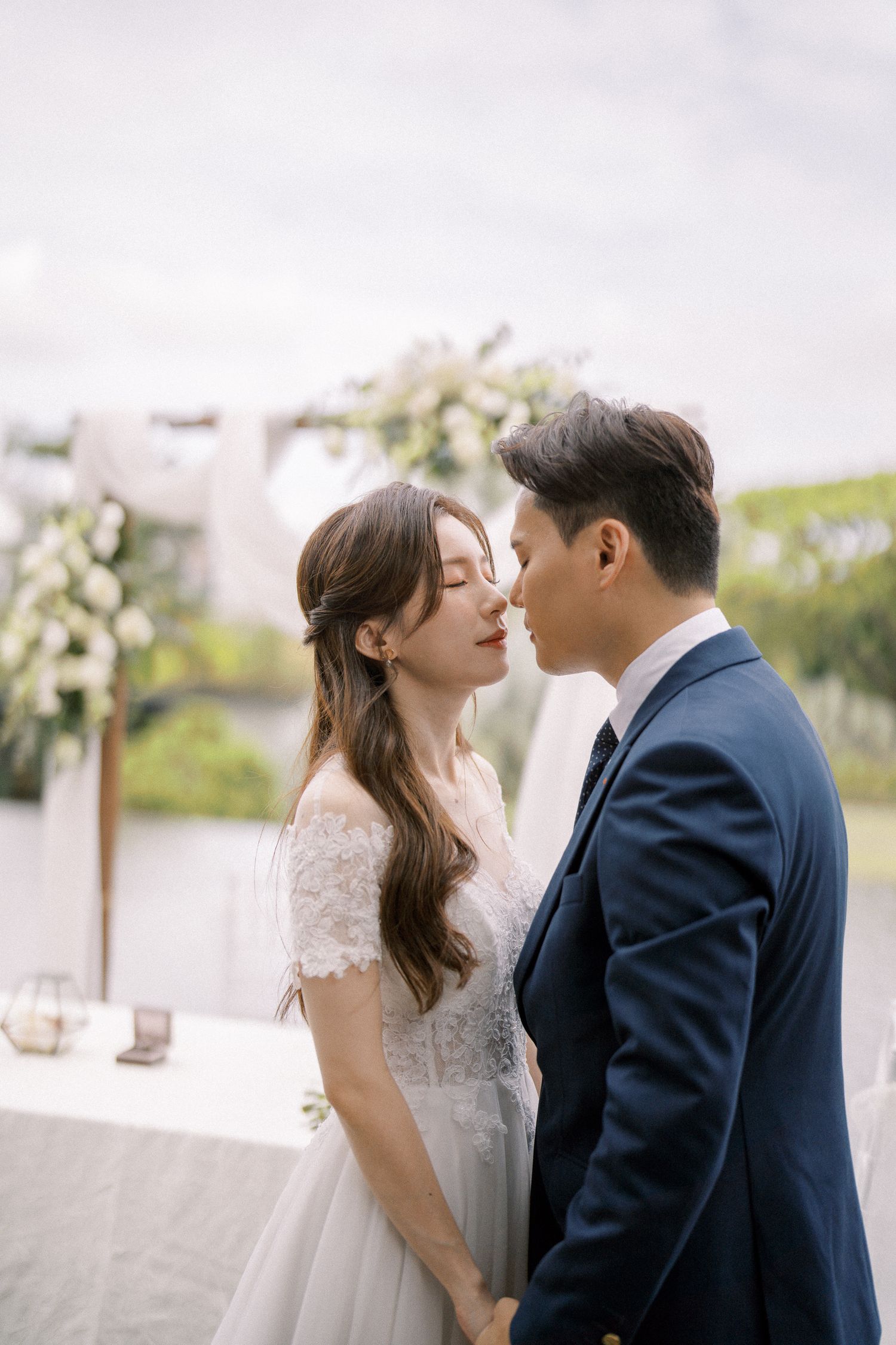 Romantic wedding moment captured in an outdoor garden setting.