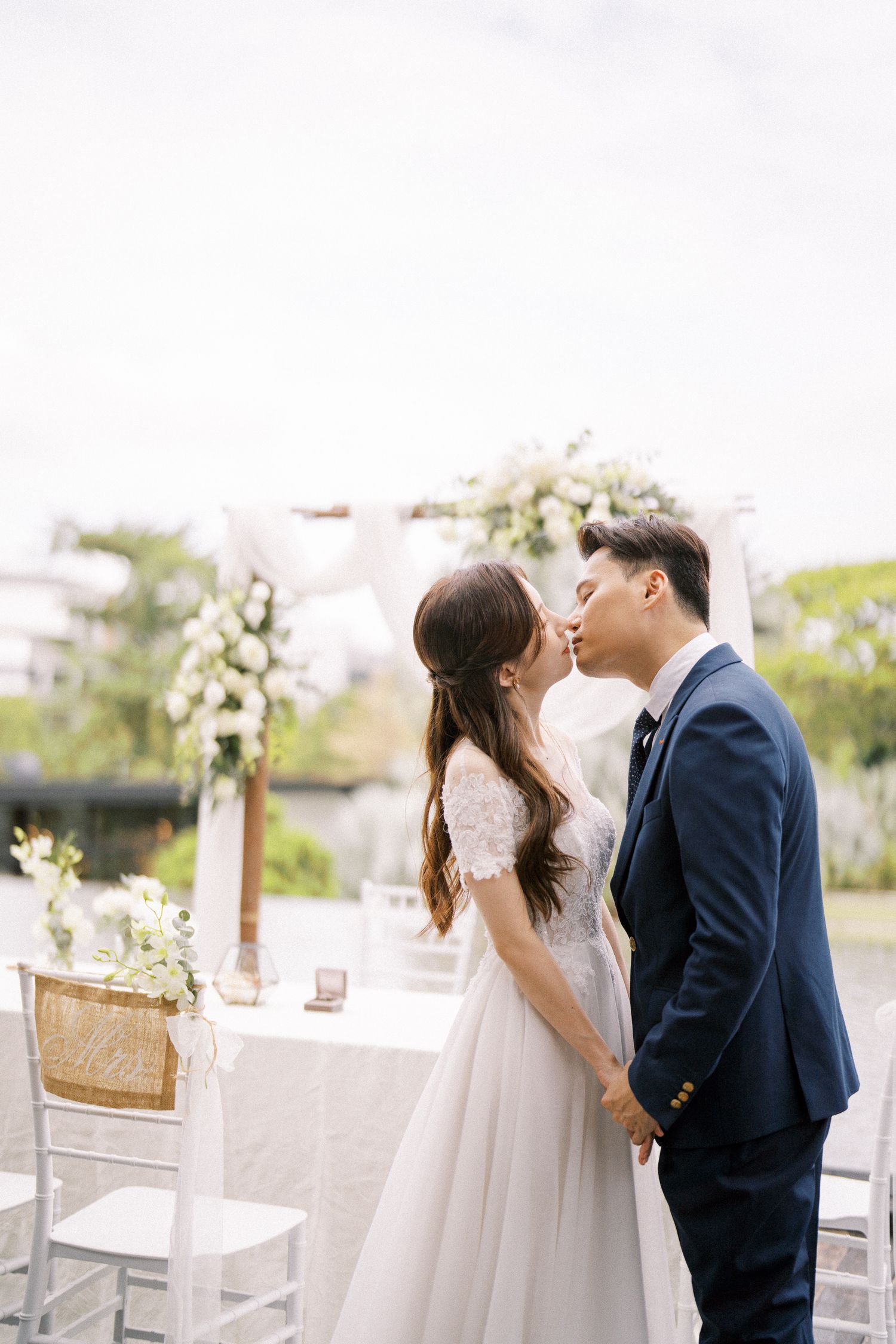 Intimate wedding ceremony moment in a sunlit outdoor venue.