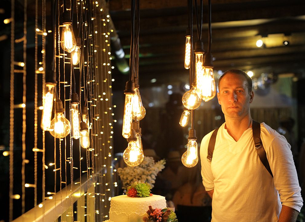 Romantic indoor setting with hanging Edison bulbs creating warm ambient lighting.