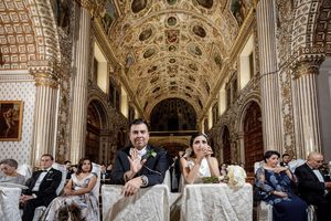 Ornate cathedral ceiling with detailed architectural elements during wedding ceremony.