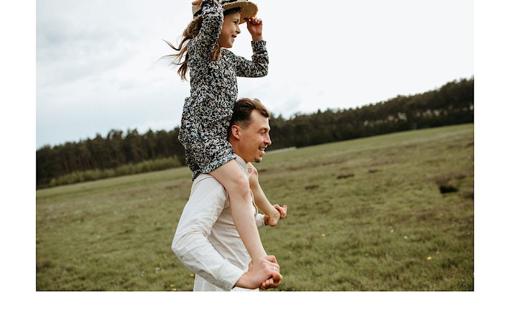Candid outdoor photography session in a rustic field setting.
