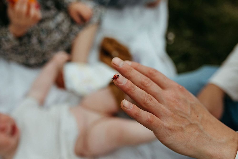 Close-up details of hands during an intimate outdoor photo session.