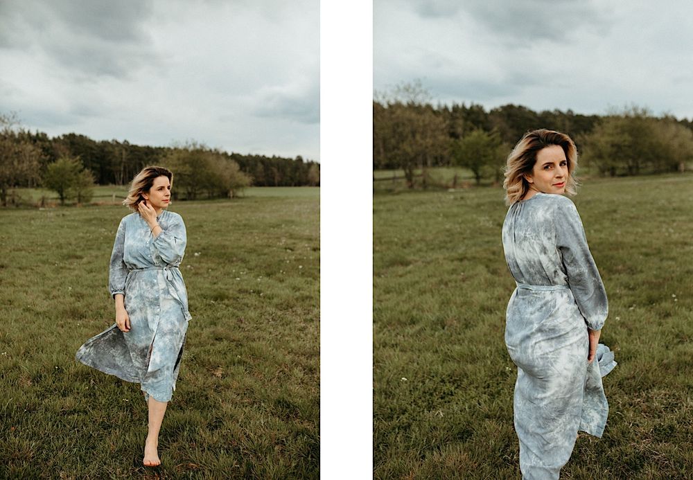 A flowy light blue dress twirls in motion against a natural outdoor backdrop.