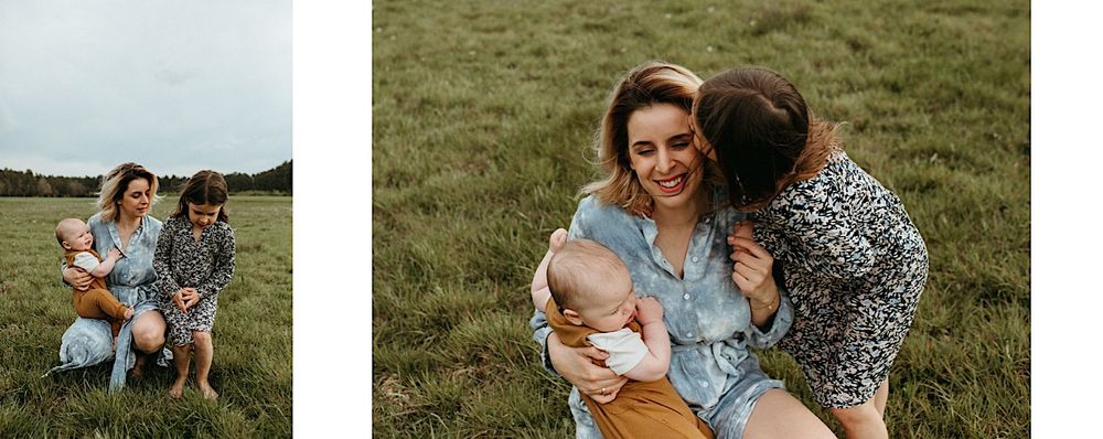 A family shares tender moments together in a scenic meadow setting.