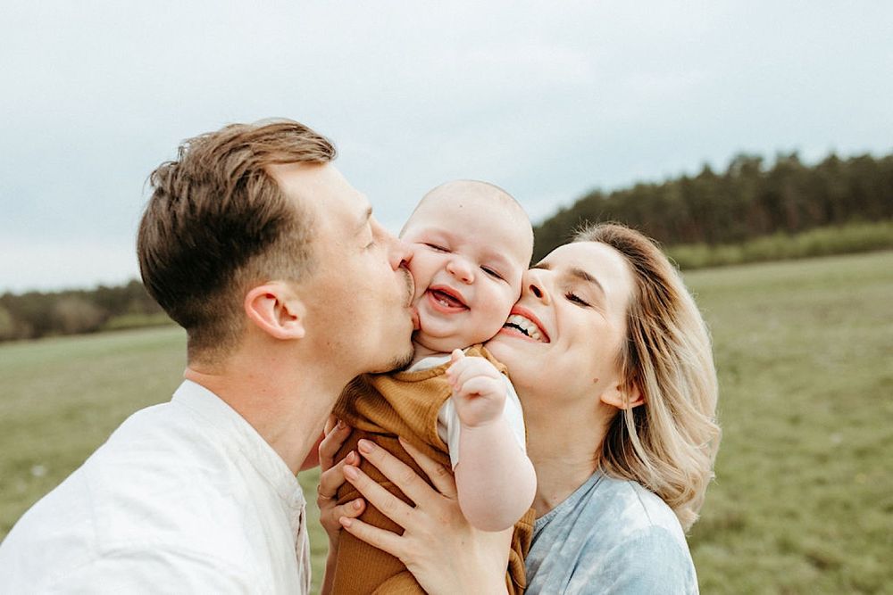 Joyful family interactions captured in a natural outdoor setting during golden hour.