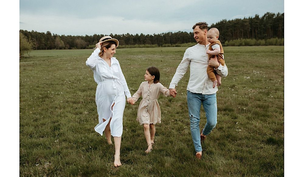 Series of candid moments showing family walking and playing in open field.