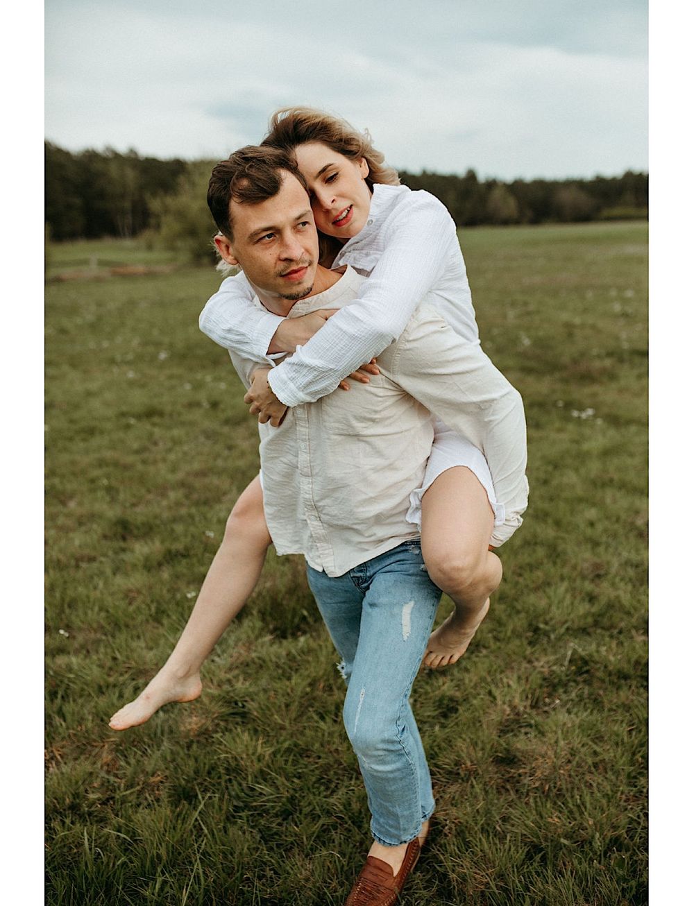 A piggyback ride scene with two people in casual attire outdoors.
