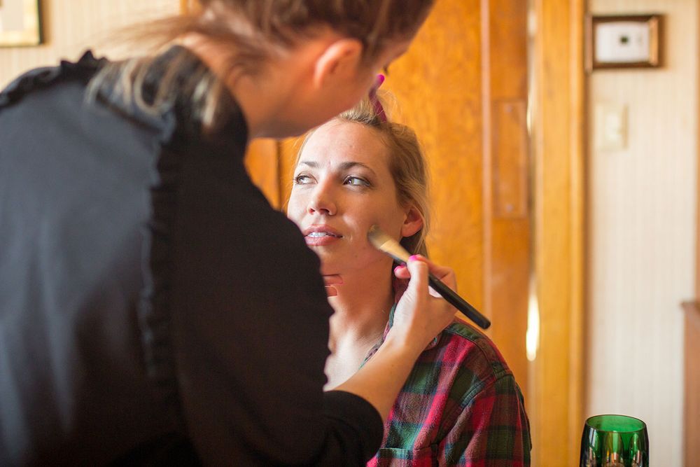 Wedding preparation scene with warm lighting and rustic wooden interior.