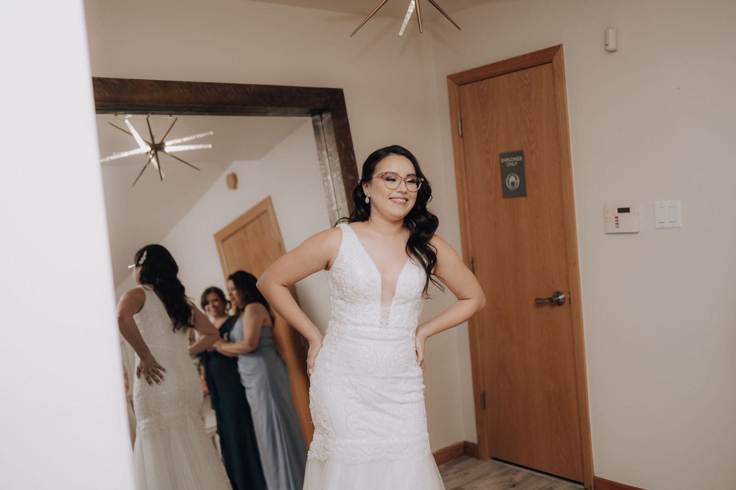 Wedding preparation scene with people in formal attire getting ready in a bedroom.