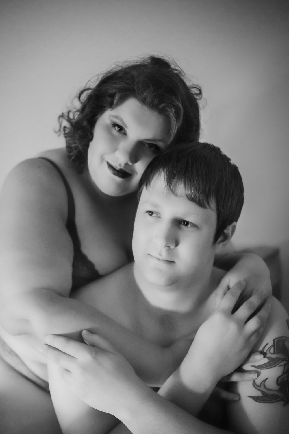 A moody black and white portrait showcasing intimate connection between two people.