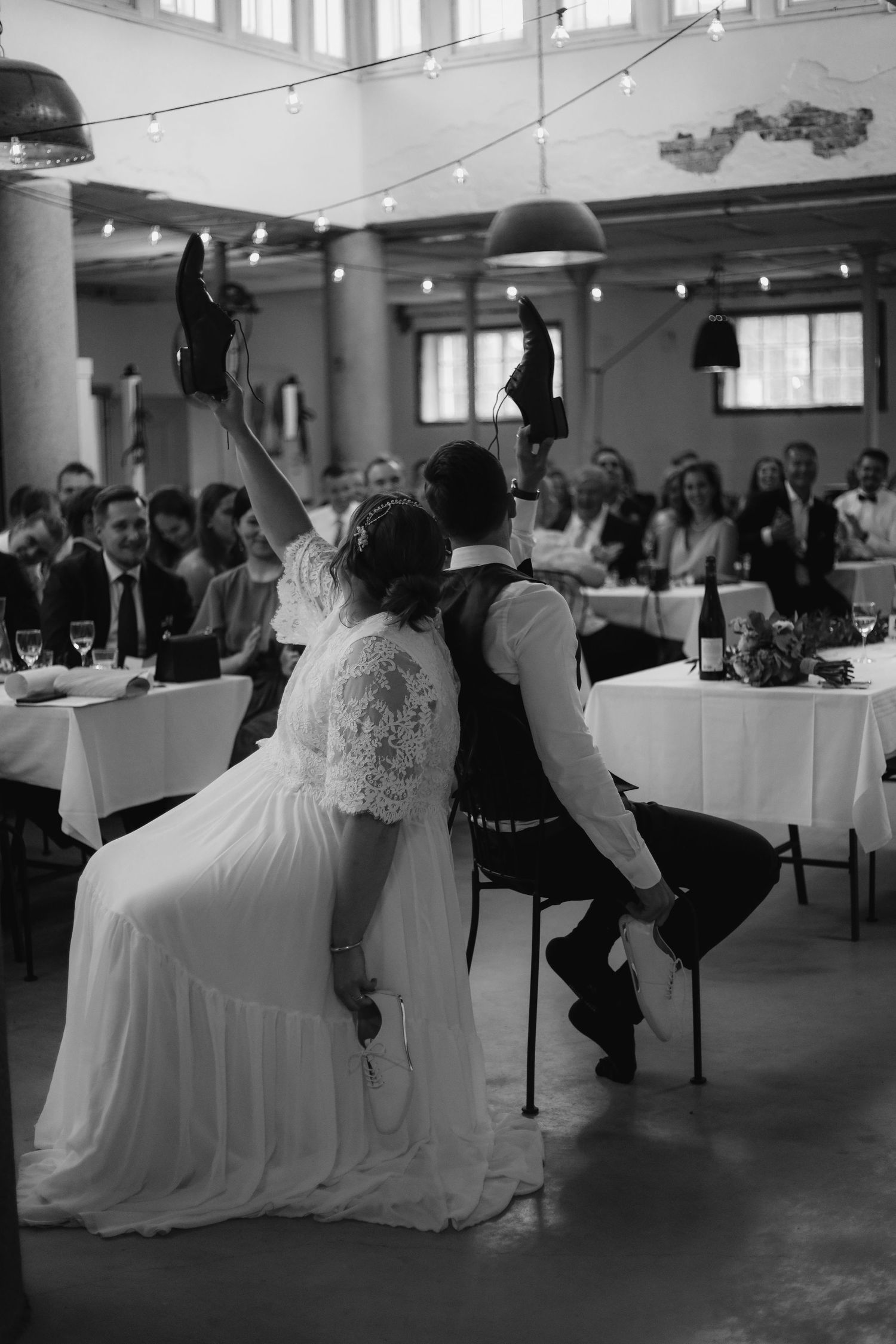 Wedding reception scene showing a couple playing a game at their celebration.