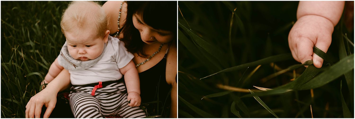 Close-up of baby and caregiver sitting in grass, with detail of small hand reaching.