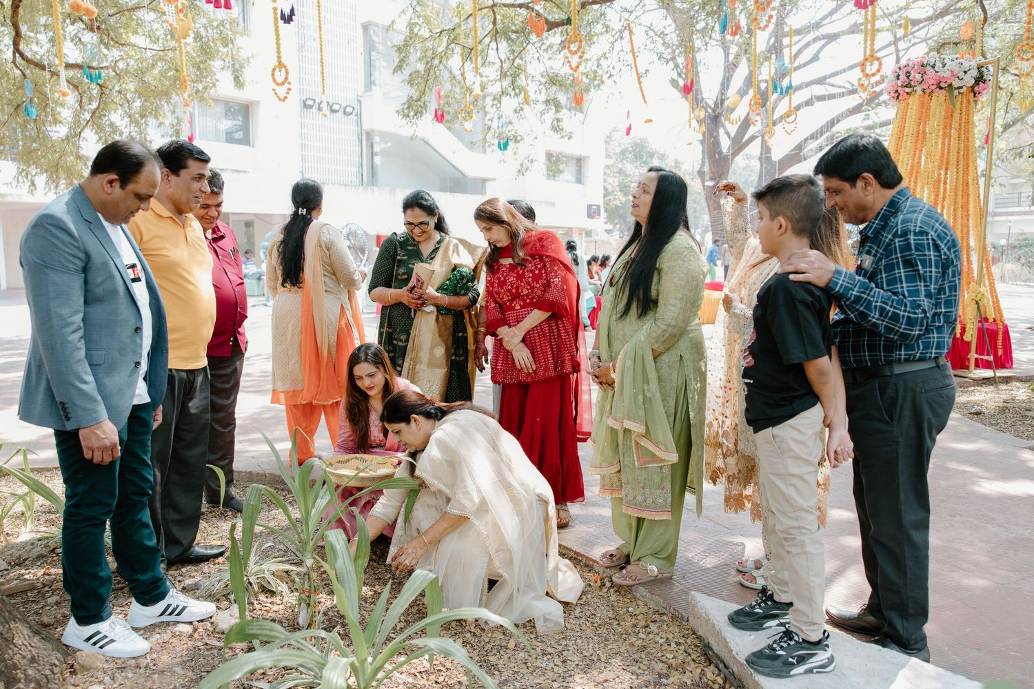 Wedding guests enjoy an outdoor celebration with colorful decorations and traditional outfits.