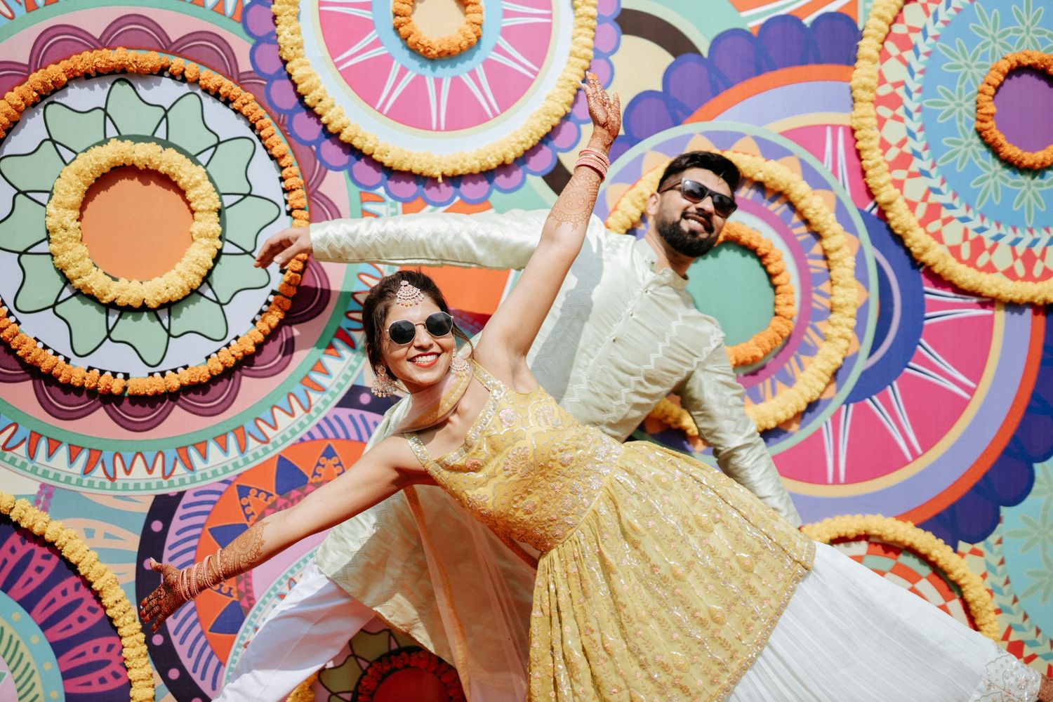 Festive celebration against a colorful geometric backdrop with circular patterns in pink and blue.
