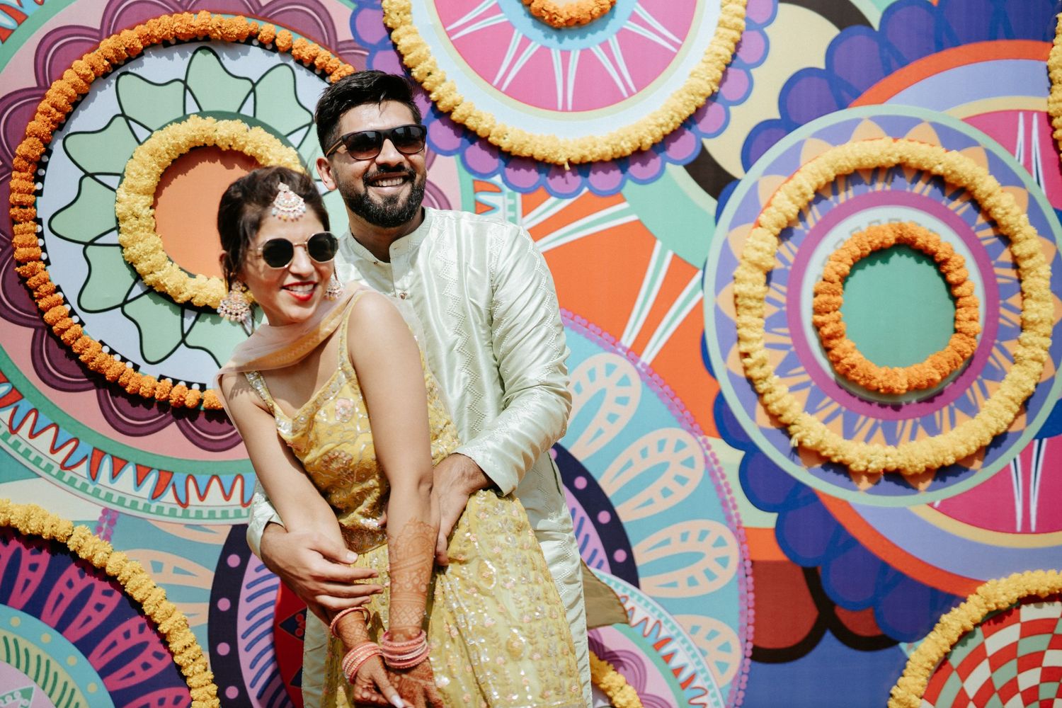 Joyous moments captured against a vibrant backdrop of circular mandala patterns in pastel colors.