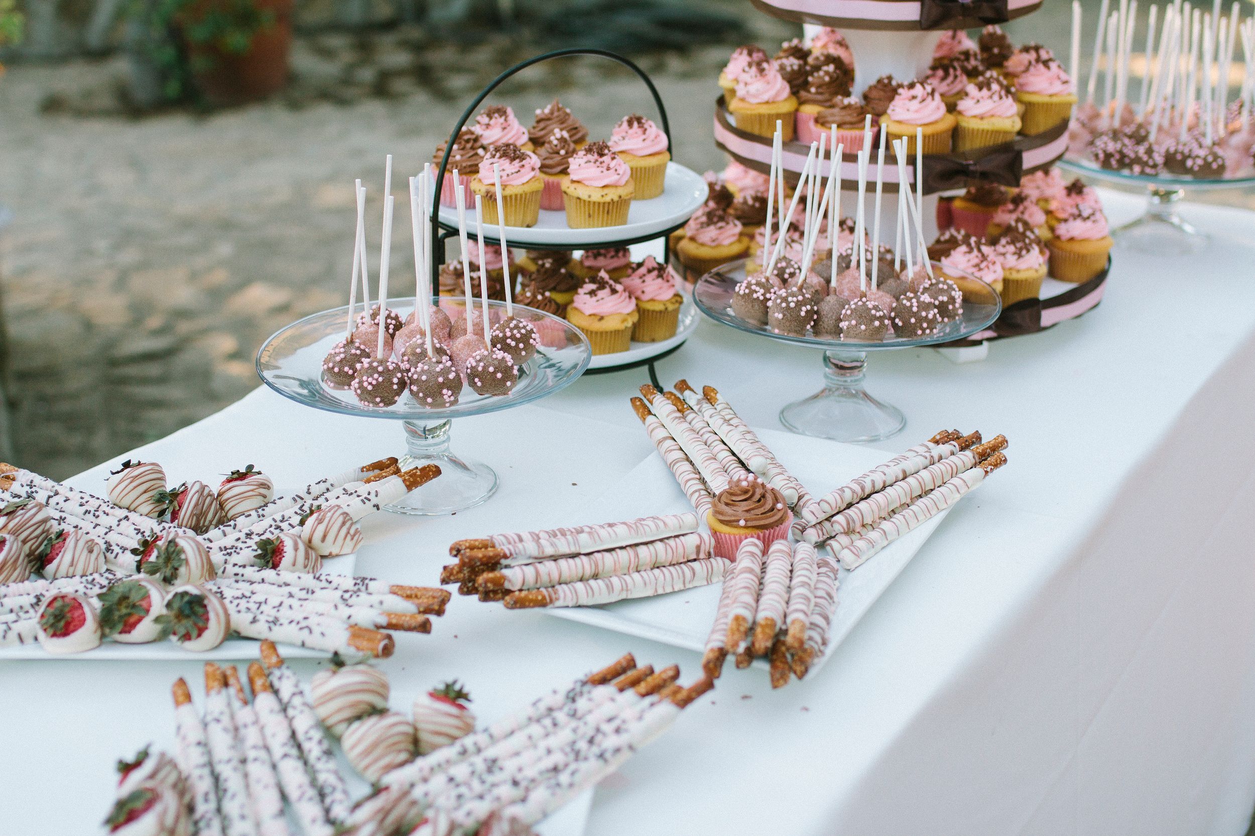 Wedding dessert table with elegant pastries and treats.