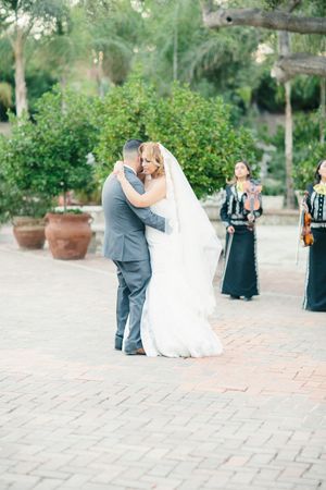 Wedding celebration on brick paved courtyard surrounded by lush garden landscaping.