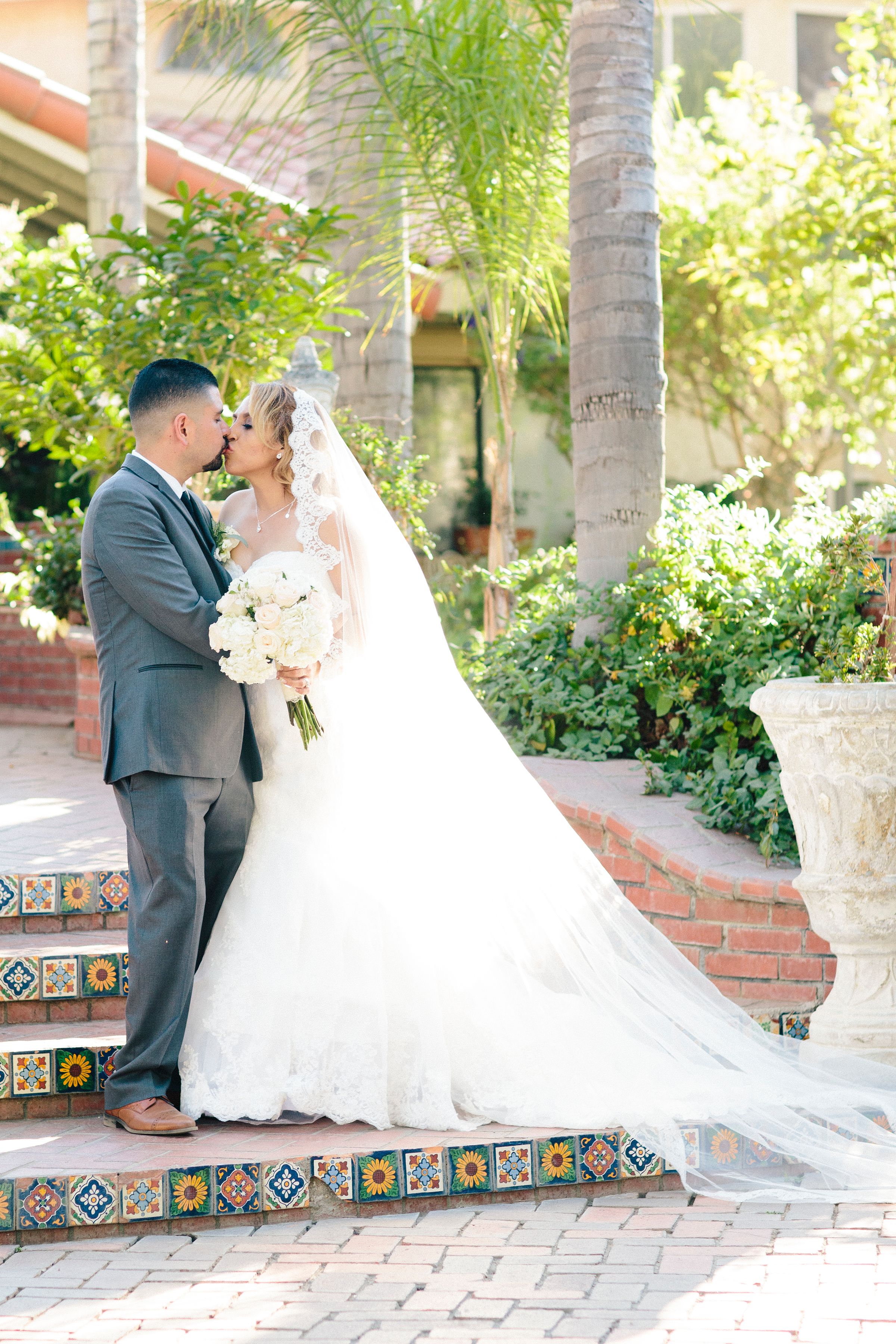 Series of romantic wedding photos taken on Spanish tile steps with palm trees in background.