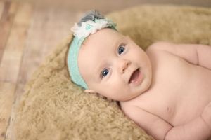 baby with head band smiling