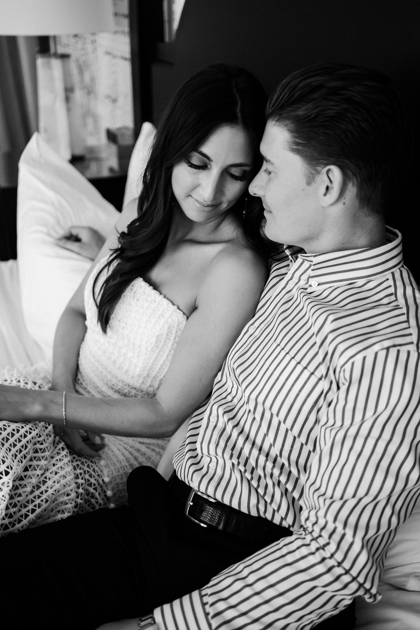 Couple engagement photo looking in love in a room at The Lodge at St. Edward Park