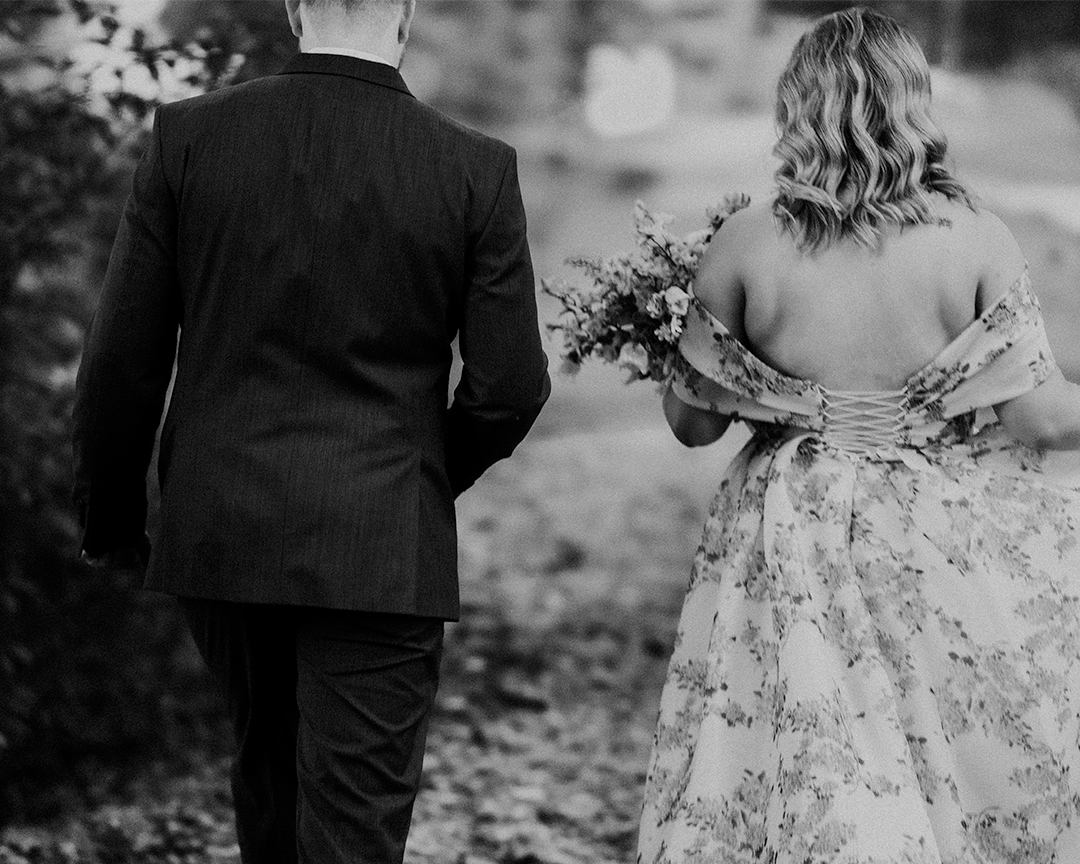 ELOPING AT HOME, couple walking away through leaves. Black & white.