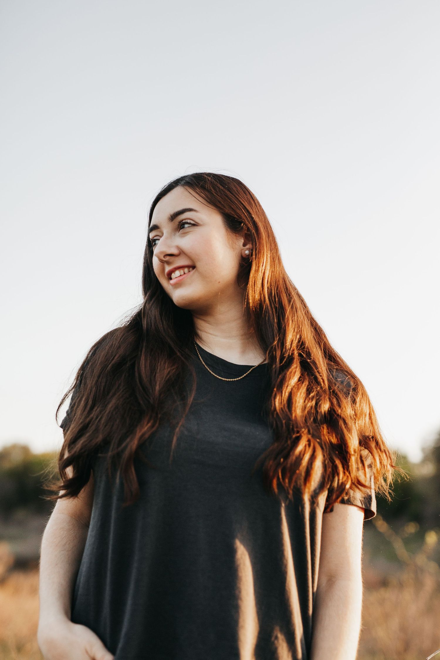 Woman standing in golden light in a field