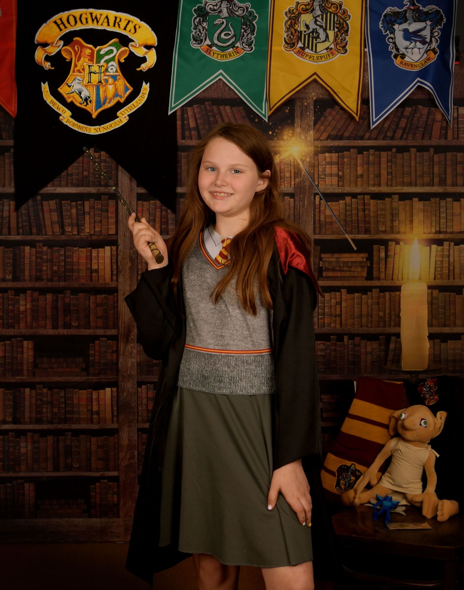 A Hogwarts-themed photo with house banners and a library backdrop featuring magical school attire.