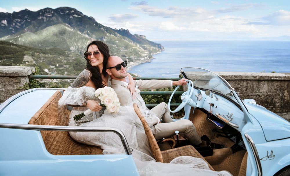 Newlyweds enjoying a scenic coastal drive in a vintage convertible along the Mediterranean.