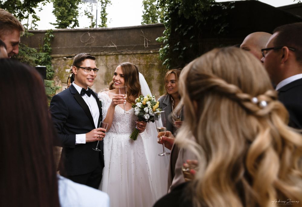 Wedding guests gather around during an outdoor ceremony.