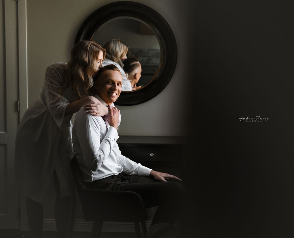 Artistic black and white portrait session featuring dramatic indoor lighting and reflections.