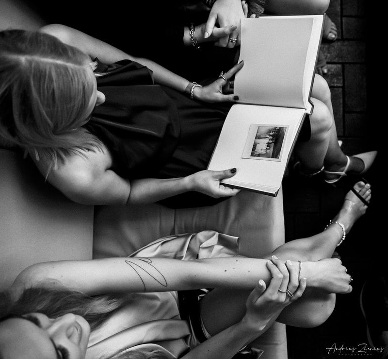 Wedding preparations captured in black and white as gifts are opened and shared.