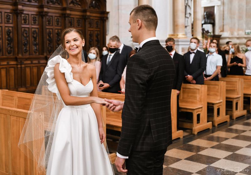 Classic church wedding ceremony with ornate wooden pews and traditional decorations.