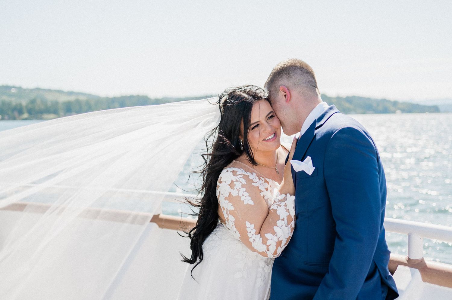 Bride and groom enjoying a yacht ride on wedding day.