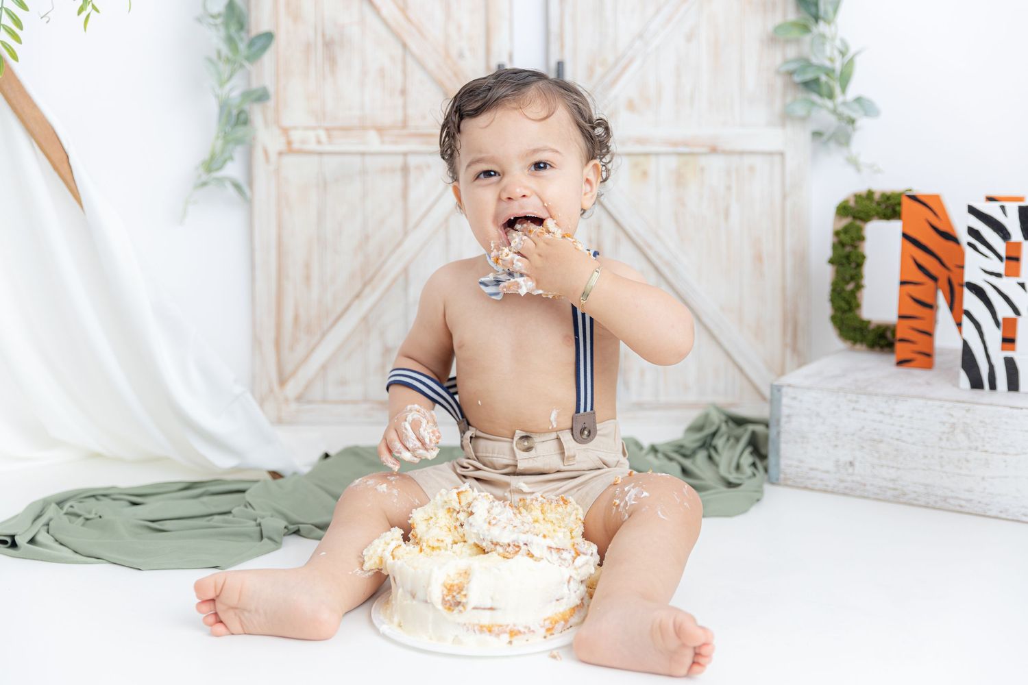 Studio setup with rustic white barn door backdrop and decorative fall elements.