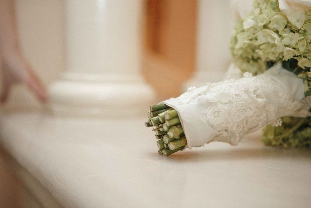 A row of elegant wedding floral decorations with white hydrangeas and greenery displayed on a light background.