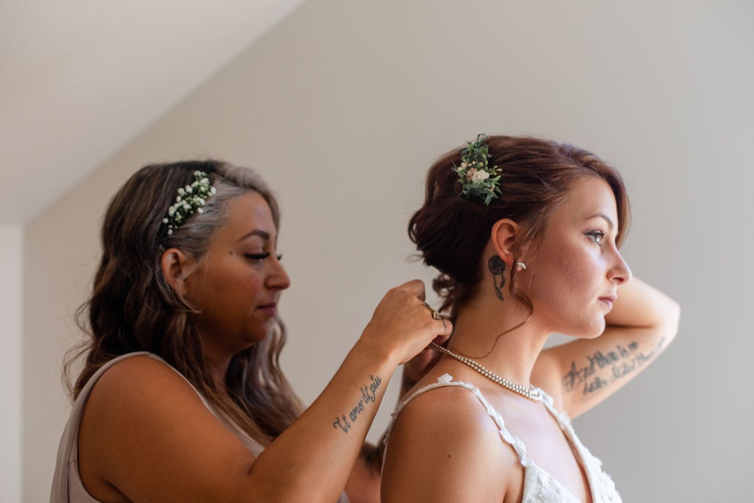 Wedding party members preparing and adjusting formal attire and accessories.